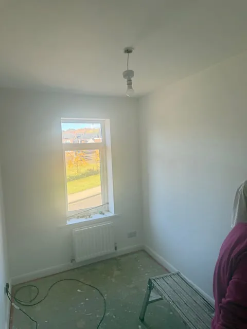 Small bedroom freshly painted with a new radiator